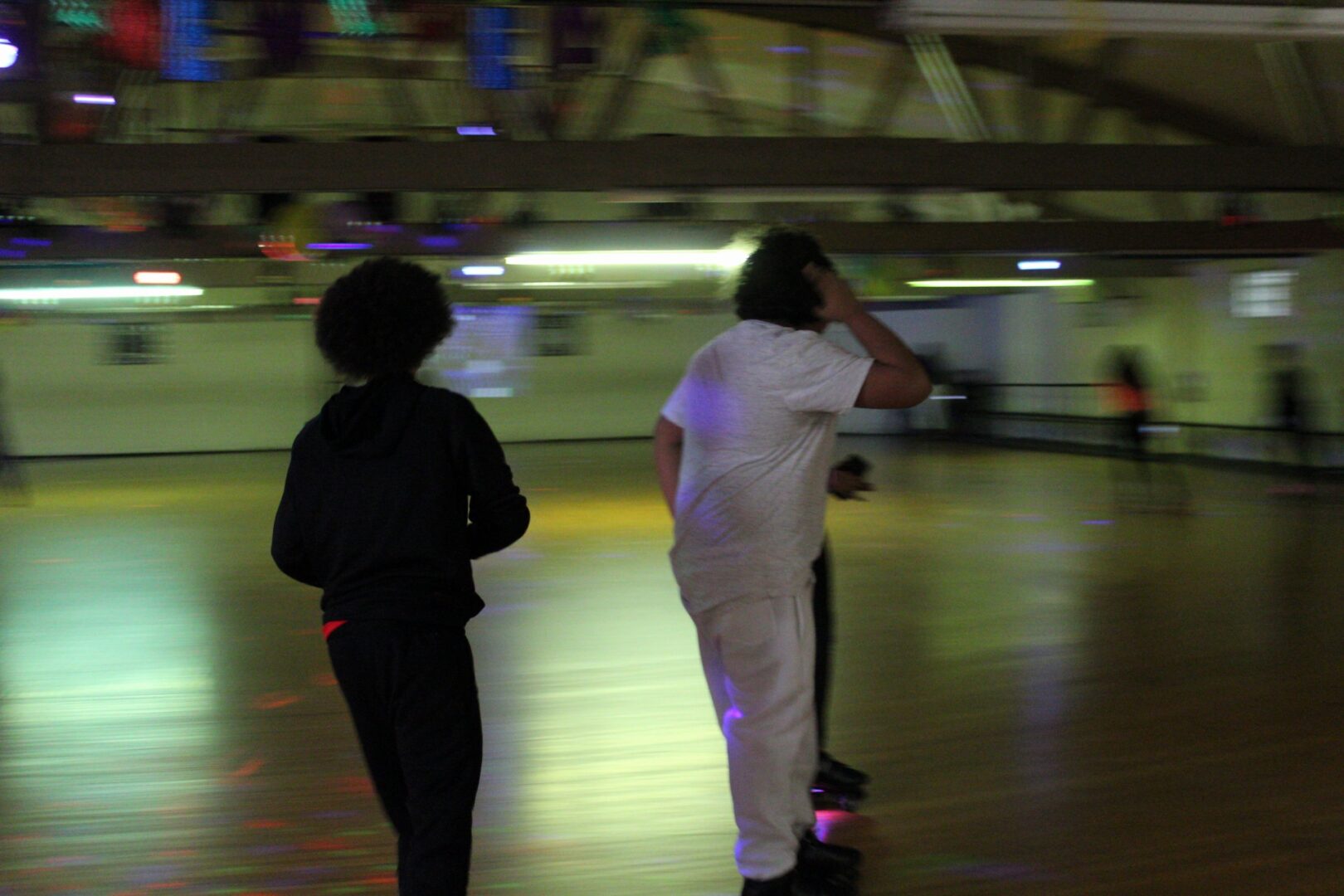 Three individuals skating on our roller rink